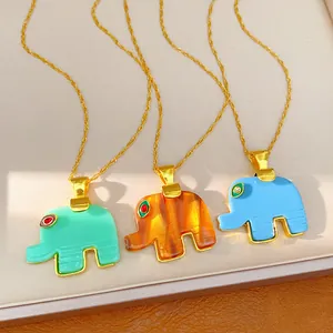 Close-up of three vibrant resin elephant pendants on gold-tone chains for women jewelry