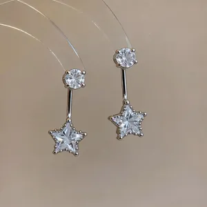 Macro detail view of elegant star-shaped zircon pendant earrings with a polished silver finish
