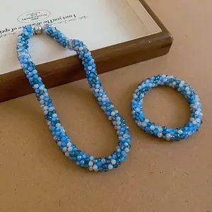Macro view showing the intricate blue and white woven crystal beads of the jewelry set