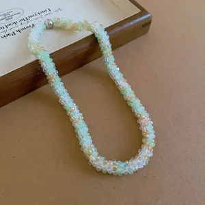 Close-up of handmade woven beaded necklace with mint green and clear crystal beads