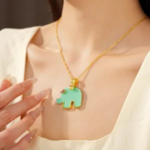Detailed view of an elegant mint green resin elephant pendant necklace on a model