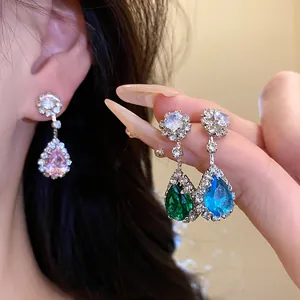 Detail view of elegant teardrop zircon earrings with vibrant pink, green and blue crystals