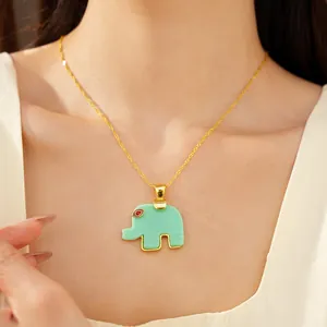 Detailed view of a green resin elephant pendant necklace on a delicate gold-plated chain