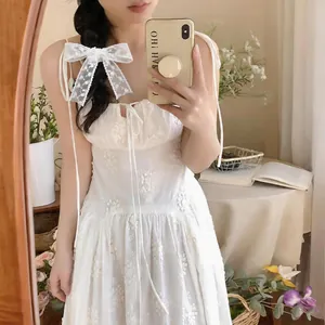 Elegant white lace ribbon scarf tied as a bow hair accessory for romantic and fresh styling