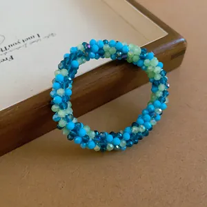 Detailed macro shot of the colorful faceted crystal beads in a braided jewelry design