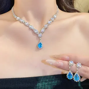 Close-up detail of elegant zircon water drop pendant necklace and earrings jewelry set
