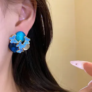 Elegant vintage silver needle enamel butterfly stud earrings with blue stones on ear model