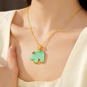 Close-up detailed view of a light green resin elephant pendant on a gold-plated chain