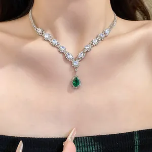 Close-up of elegant green water drop pendant necklace with shimmering cubic zirconia