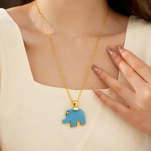 Close-up of a blue resin elephant pendant necklace worn on a woman's neck for detail display