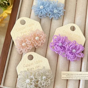 Elegant handcrafted beaded flower stud earrings with pearl centers in soft colors