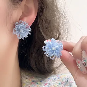 Elegant light blue beaded flower stud earrings featuring a pearl center in Korean style