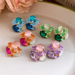Close-up of retro butterfly stud earrings with colorful enamel and crystal details