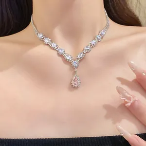 Close-up of a sparkling zirconia water-drop pendant necklace on a model's neck
