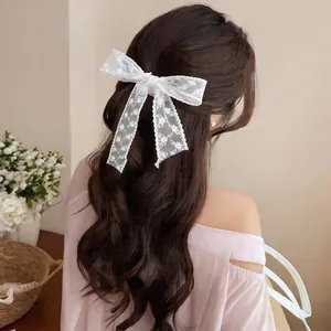 Detailed close-up showing elegant white lace floral bow hair ribbon on wavy hair