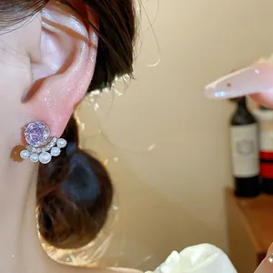 Close-up macro detail of elegant French style purple zircon flower stud earring with small pearls