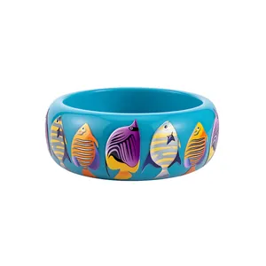 Vibrant dopamine style resin bangle featuring colorful tropical fish prints on a bright blue base