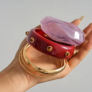 Detailed view of a 4-piece retro resin and gold-tone metal bangle bracelet set