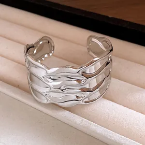 Detail view showing the wavy metallic texture of a vintage silver open cuff bracelet