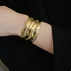 Detailed close-up showing a vintage gold wavy texture open cuff bracelet for women