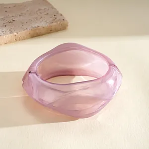 Close-up view of a vintage purple translucent resin faceted bangle with hinge detail
