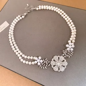 Elegant double-layer pearl necklace featuring a luxury rhinestone flower pendant accessory