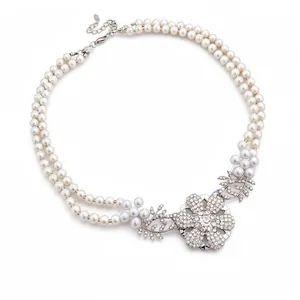 Elegant double-layered pearl necklace with sparkling rhinestone floral pendant
