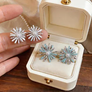Elegant firework stud earrings with pearls and zircons in white and blue enamel colors