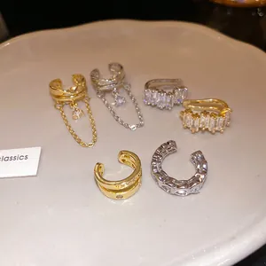 Close-up of elegant 18k gold plated ear cuffs set with sparkling heart shaped zircons