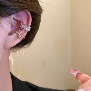 Detailed view of 18k gold plated zircon ear cuffs on ear bone for a luxurious look.