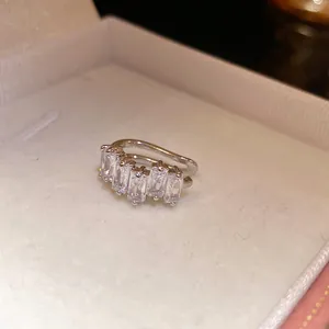 Detail of silver ear cuff with rectangular zirconia stones in a jewelry box