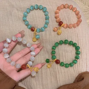 Detail of Chinese style cat-eye stone beaded bracelets in four vibrant colors