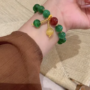 Retro cat's eye stone beaded bracelet with colorful charms worn on wrist