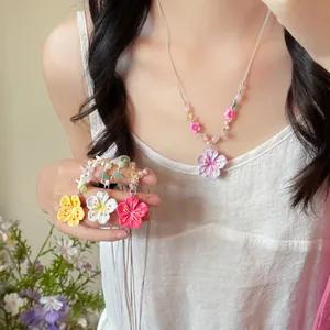 Gros plan d'un collier de perles à fleurs colorées pour femmes de style dopamine