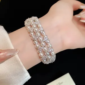 Close-up detail showing the lustrous pearls and sparkling zircons of the multi-layer bracelet