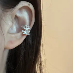 Close-up detail of an elegant silver wheat ear cuff adorned with sparkling zircons