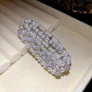 Detailed macro view of an elegant multi-layer pearl and zircon flower bracelet