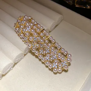 Close-up of vintage multi-layer pearl bracelet with sparkling zircon flower accents