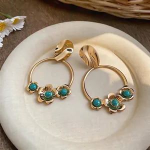 Elegant French vintage gold hoop earrings featuring flower charms and turquoise beads