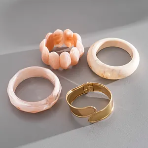 Collection of stylish acrylic marble texture and gold metallic bangles for fashion women