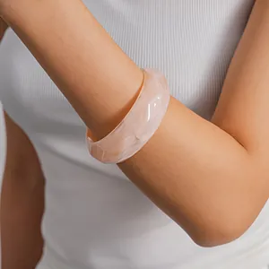Elegant marbled acrylic geometric bangle bracelet shown on model for accessory details