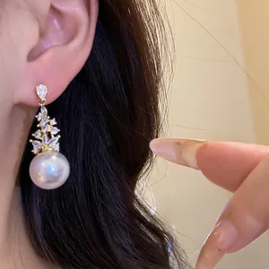 Elegant vintage style zircon and pearl drop earrings shown on model for a luxury aesthetic
