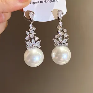 Vintage silver needle drop earrings with zircon floral detail and large white pearls