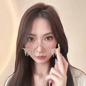 Close-up of elegant gold rhinestone tassel lensless glasses frame on female model