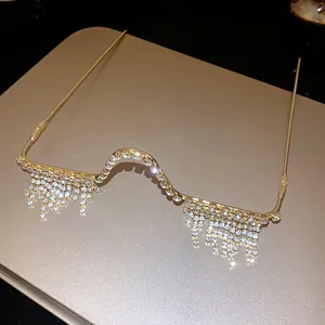 Macro detail of luxury golden eyeless spectacle frame with sparkling rhinestone fringe tassels
