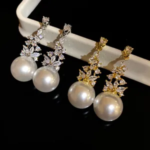 Detail of elegant vintage pearl drop earrings with sparkling cubic zirconia stones.