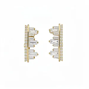 Elegant gold geometric earrings with irregular zircon baguette crystals on white