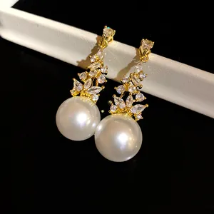 Elegant vintage style pearl and zircon drop earrings in a sparkling gold finish.