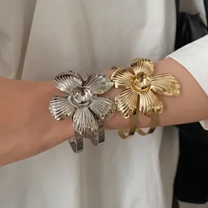 Vintage gold and silver flower metal cuff bracelets featuring elegant leaf texture detailing