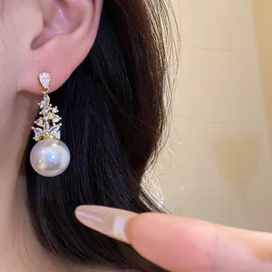 Macro detail of elegant vintage pearl dangle earrings with shimmering CZ stones